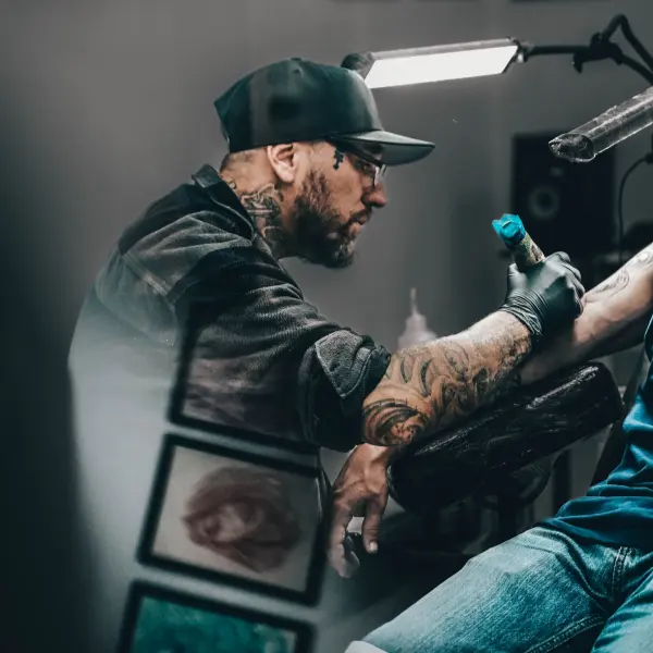 Sebastian tattoo artist at Mad Family Tattoo Studio working on a tattoo in Tenerife